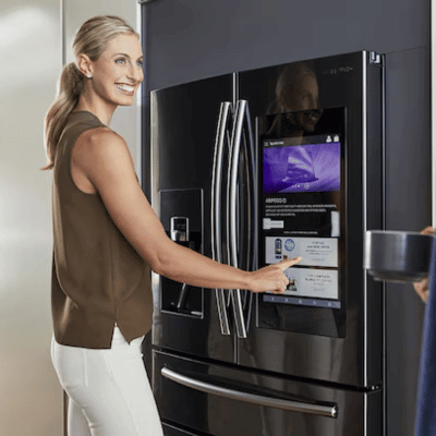 Woman using the hub of the kitchen refrigerator