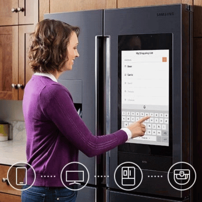 Woman using a smart appliance in the kitchen